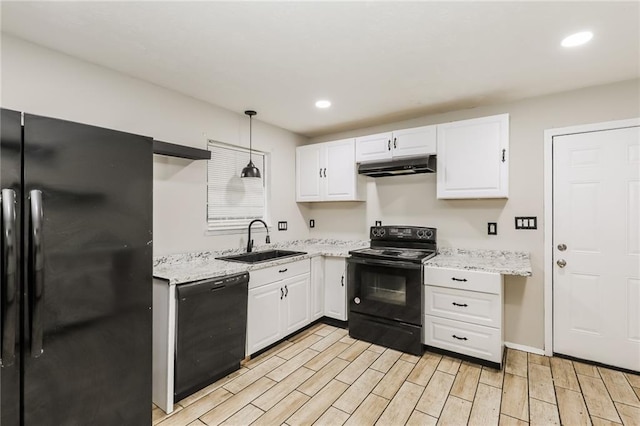 kitchen featuring black appliances, a sink, under cabinet range hood, white cabinets, and recessed lighting