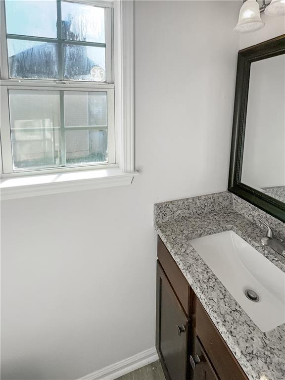 bathroom featuring a healthy amount of sunlight and vanity