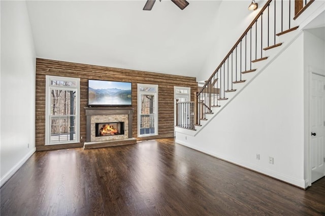 8625 Anchor On Lanier Ct, Gainesville, GA 30506 - unfurnished living room featuring high vaulted ceiling, ceiling fan, stairway, wood finished floors, and a lit fireplace