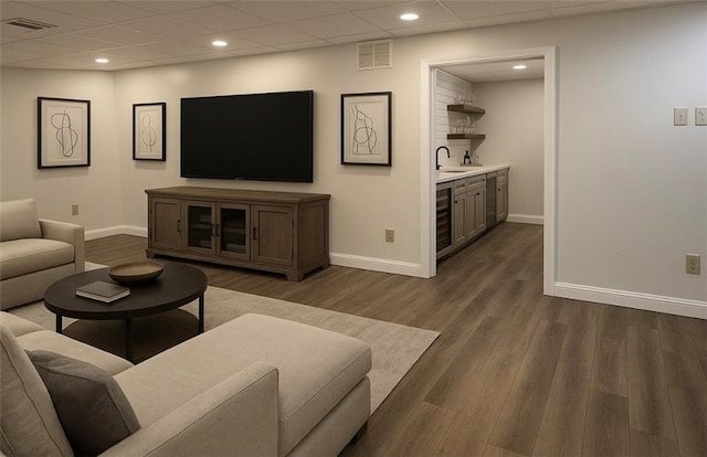 8625 Anchor On Lanier Ct, Gainesville, GA 30506 - living area featuring bar with sink, dark wood-style flooring, recessed lighting, beverage cooler, and a drop ceiling