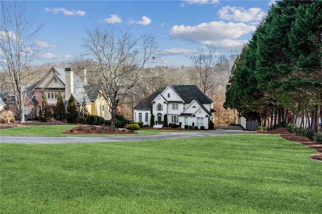 8625 Anchor On Lanier Ct, Gainesville, GA 30506 - view of front of house featuring a chimney, asphalt driveway, and a front lawn