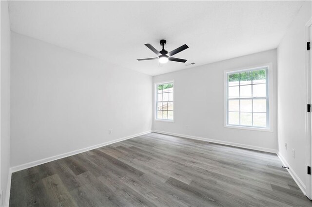 1031 Abercorn Way, Douglasville, GA 30134 - spare room with wood finished floors, a healthy amount of sunlight, and a ceiling fan