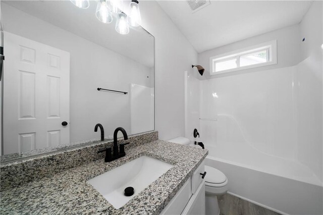 1031 Abercorn Way, Douglasville, GA 30134 - bathroom featuring visible vents, toilet, wood finished floors, vanity, and bathtub / shower combination