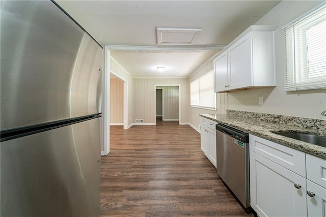 3904 W Hilda Cir, Decatur, GA 30035 - kitchen featuring appliances with stainless steel finishes, white cabinets, dark wood finished floors, and light stone countertops