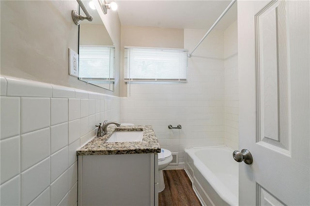 3904 W Hilda Cir, Decatur, GA 30035 - bathroom featuring tile walls, vanity, bathtub / shower combination, and wood finished floors