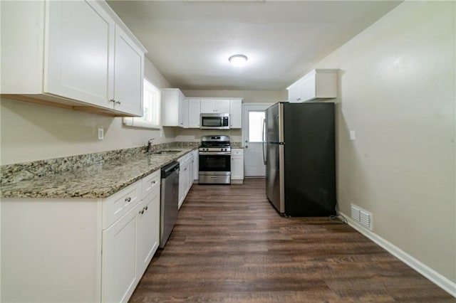 3904 W Hilda Cir, Decatur, GA 30035 - kitchen with stainless steel appliances, white cabinetry, dark wood-style floors, and light stone counters