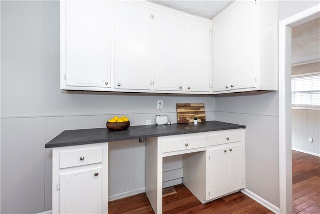 kitchen with white cabinetry and dark hardwood / wood-style floors