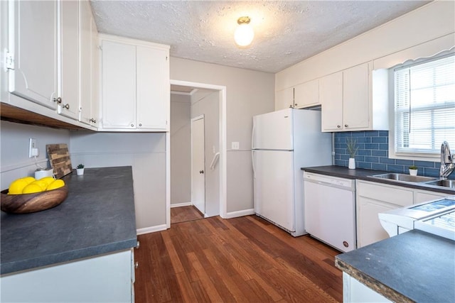 kitchen featuring sink, white cabinets, and white appliances