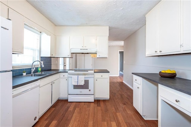 kitchen featuring sink, white appliances, dark hardwood / wood-style floors, a textured ceiling, and white cabinets