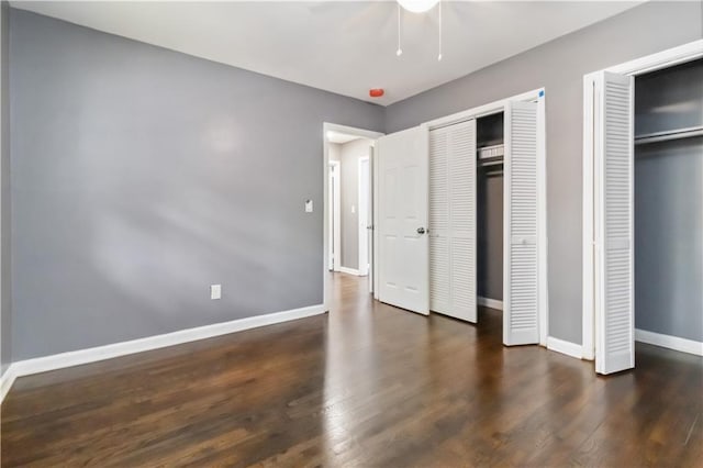 2267 Bryant Dr, East Point, GA 30344 - unfurnished bedroom with baseboards, multiple closets, ceiling fan, and wood finished floors