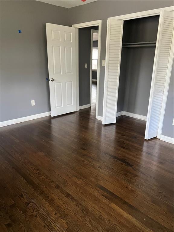 2267 Bryant Dr, East Point, GA 30344 - unfurnished bedroom featuring baseboards, dark wood finished floors, and a closet