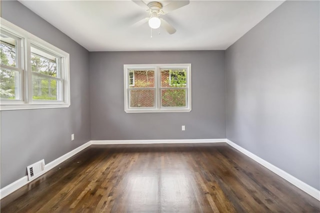 2267 Bryant Dr, East Point, GA 30344 - unfurnished room featuring a wealth of natural light, dark wood-style flooring, ceiling fan, and visible vents