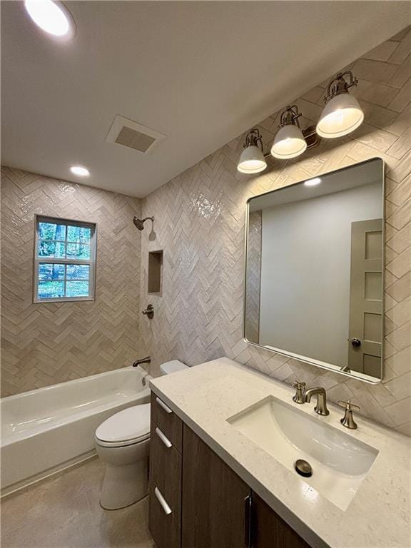 bathroom featuring visible vents, toilet, tasteful backsplash, tile walls, and tub / shower combination