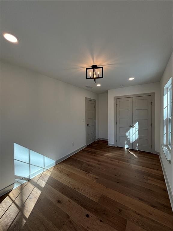 entrance foyer with recessed lighting, a chandelier, baseboards, and wood finished floors