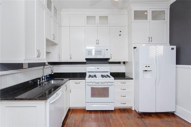 kitchen with a sink, white appliances, white cabinetry, and dark wood-style floors