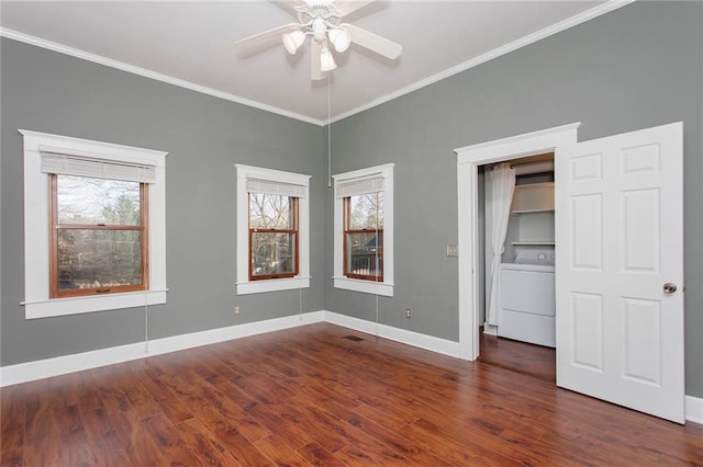 unfurnished bedroom featuring baseboards, dark wood-type flooring, washer / clothes dryer, and ornamental molding