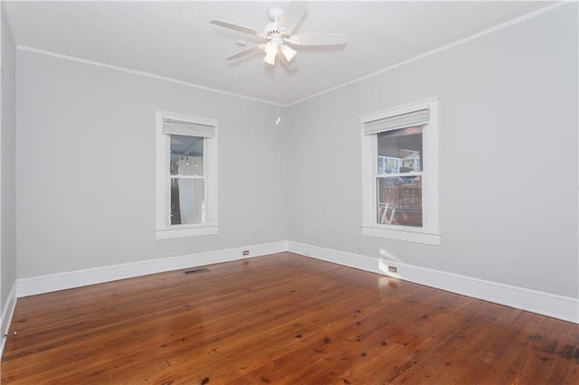 empty room with ceiling fan, ornamental molding, and baseboards