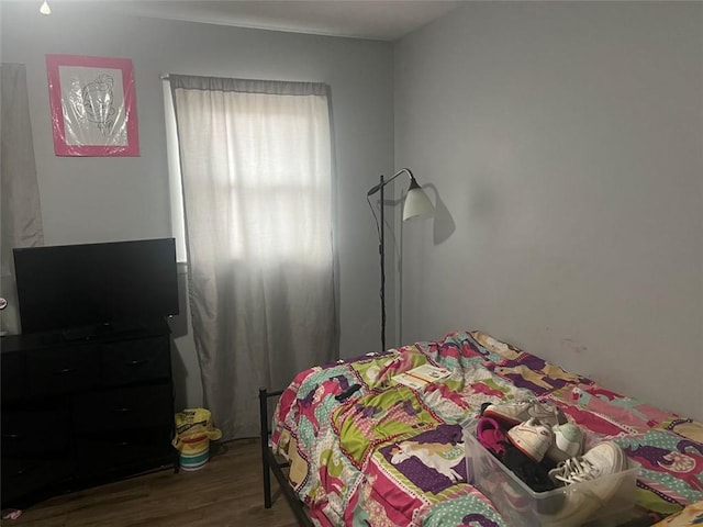 bedroom with wood finished floors