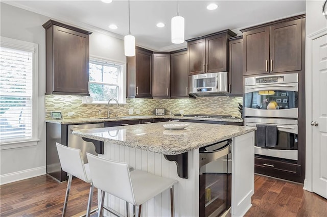 1546 Heritage Pass, Milton, GA 30004 - kitchen with wine cooler, appliances with stainless steel finishes, a sink, dark brown cabinets, and recessed lighting