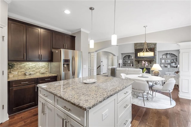 1546 Heritage Pass, Milton, GA 30004 - kitchen featuring stainless steel fridge with ice dispenser, decorative columns, crown molding, arched walkways, and dark brown cabinets