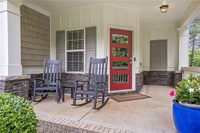 1546 Heritage Pass, Milton, GA 30004 - view of exterior entry with stone siding, board and batten siding, and covered porch