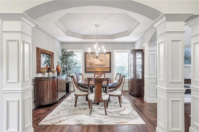 1546 Heritage Pass, Milton, GA 30004 - dining room featuring dark wood-style floors, decorative columns, arched walkways, crown molding, and a decorative wall