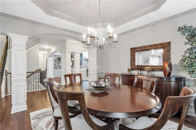 1546 Heritage Pass, Milton, GA 30004 - dining space with a raised ceiling, ornate columns, arched walkways, a chandelier, and ornamental molding
