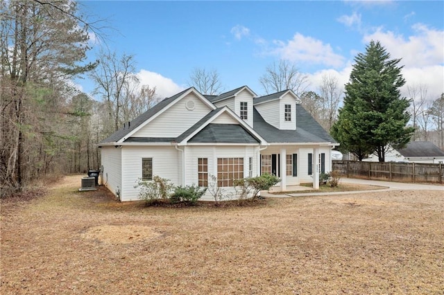 view of front of property featuring central AC and fence