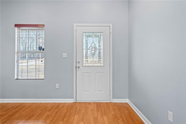 entryway featuring plenty of natural light, light wood-style flooring, and baseboards