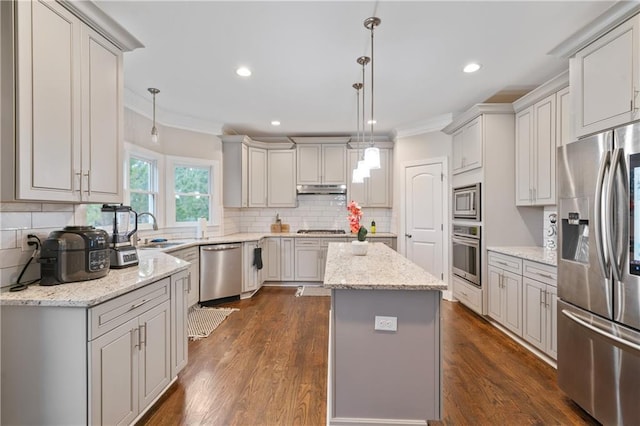 4402 Income Cir, Ellenwood, GA 30294 - kitchen with appliances with stainless steel finishes, ornamental molding, a sink, decorative backsplash, and a kitchen island