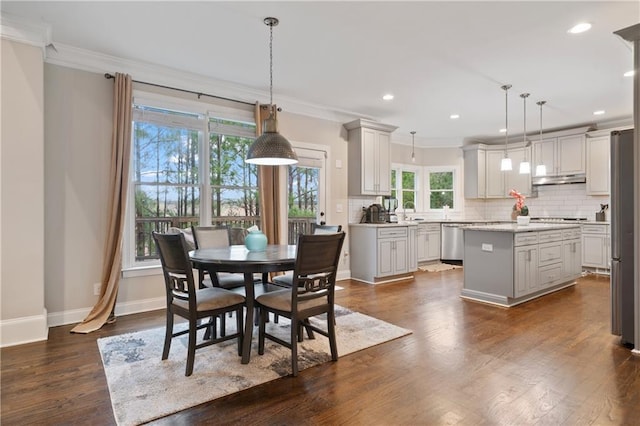 4402 Income Cir, Ellenwood, GA 30294 - dining space with crown molding, dark wood-style floors, baseboards, and recessed lighting