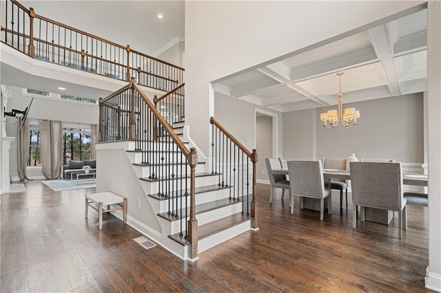 4402 Income Cir, Ellenwood, GA 30294 - staircase with a chandelier, hardwood / wood-style floors, baseboards, beamed ceiling, and coffered ceiling