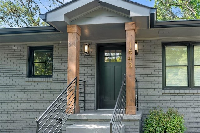 doorway to property with brick siding