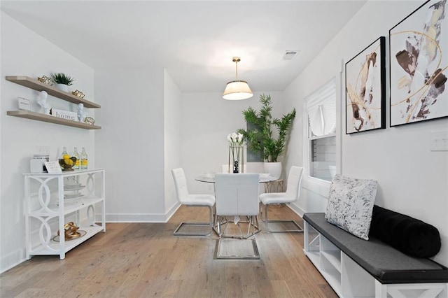 dining area with wood finished floors and baseboards