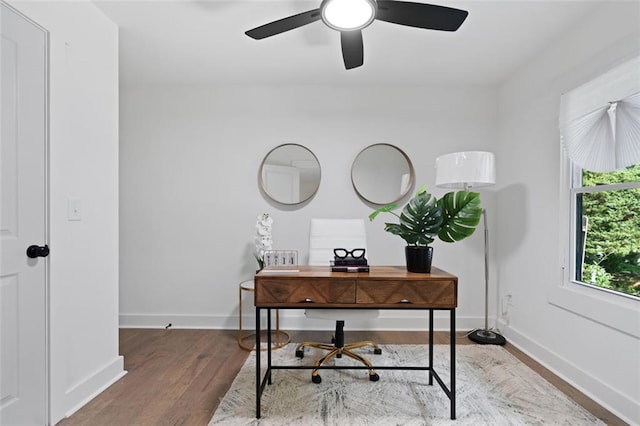 office area featuring wood finished floors, baseboards, and a ceiling fan