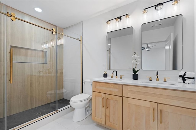 full bathroom featuring toilet, a ceiling fan, a stall shower, double vanity, and tile patterned flooring