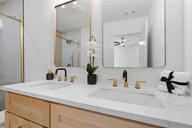 full bath with a stall shower and double vanity
