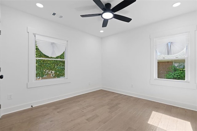 spare room featuring wood finished floors, baseboards, recessed lighting, and ceiling fan