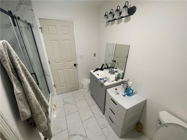 bathroom with vanity, toilet, and a shower with door