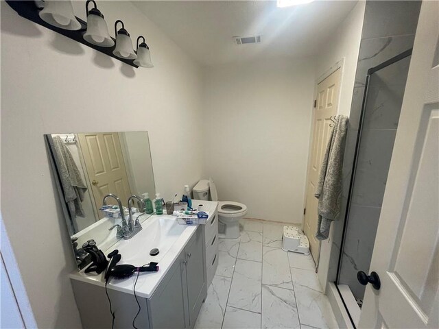 bathroom featuring vanity, a shower with shower door, and toilet