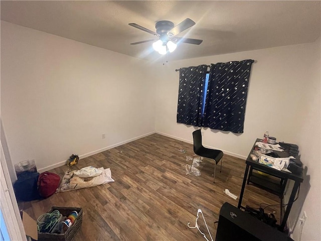 interior space with ceiling fan and dark wood-type flooring