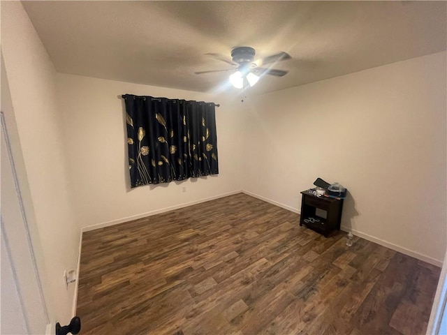 spare room with ceiling fan and dark hardwood / wood-style floors