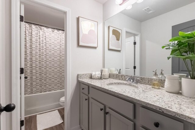 4824 Sultana Way SW, Atlanta, GA 30331 - full bath featuring vanity, shower / tub combo with curtain, toilet, visible vents, and wood finished floors
