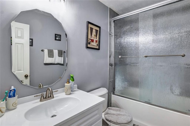 full bathroom with shower / bath combination with glass door, vanity, and toilet