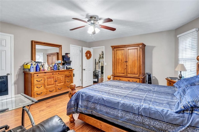 bedroom with wood-type flooring and ceiling fan