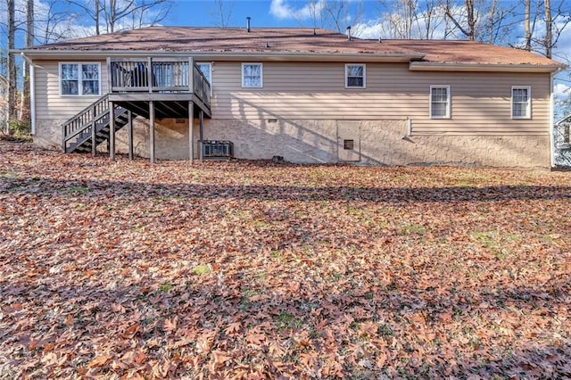 rear view of property featuring a wooden deck