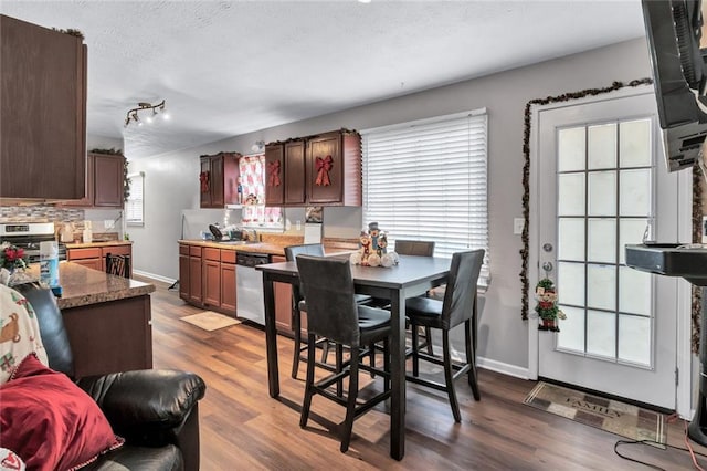 dining area featuring hardwood / wood-style floors, a textured ceiling, and sink