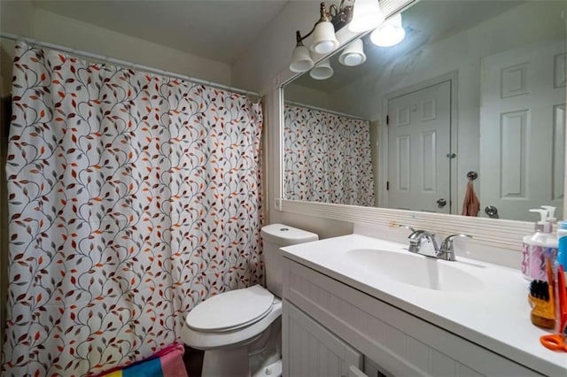 bathroom with toilet and vanity