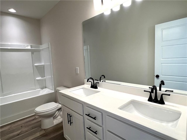 full bathroom featuring bathing tub / shower combination, vanity, hardwood / wood-style flooring, and toilet