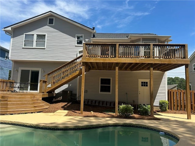 4811 Nevilly Way, Marietta, GA 30066 - rear view of house featuring stairway, fence, a wooden deck, and an outdoor pool